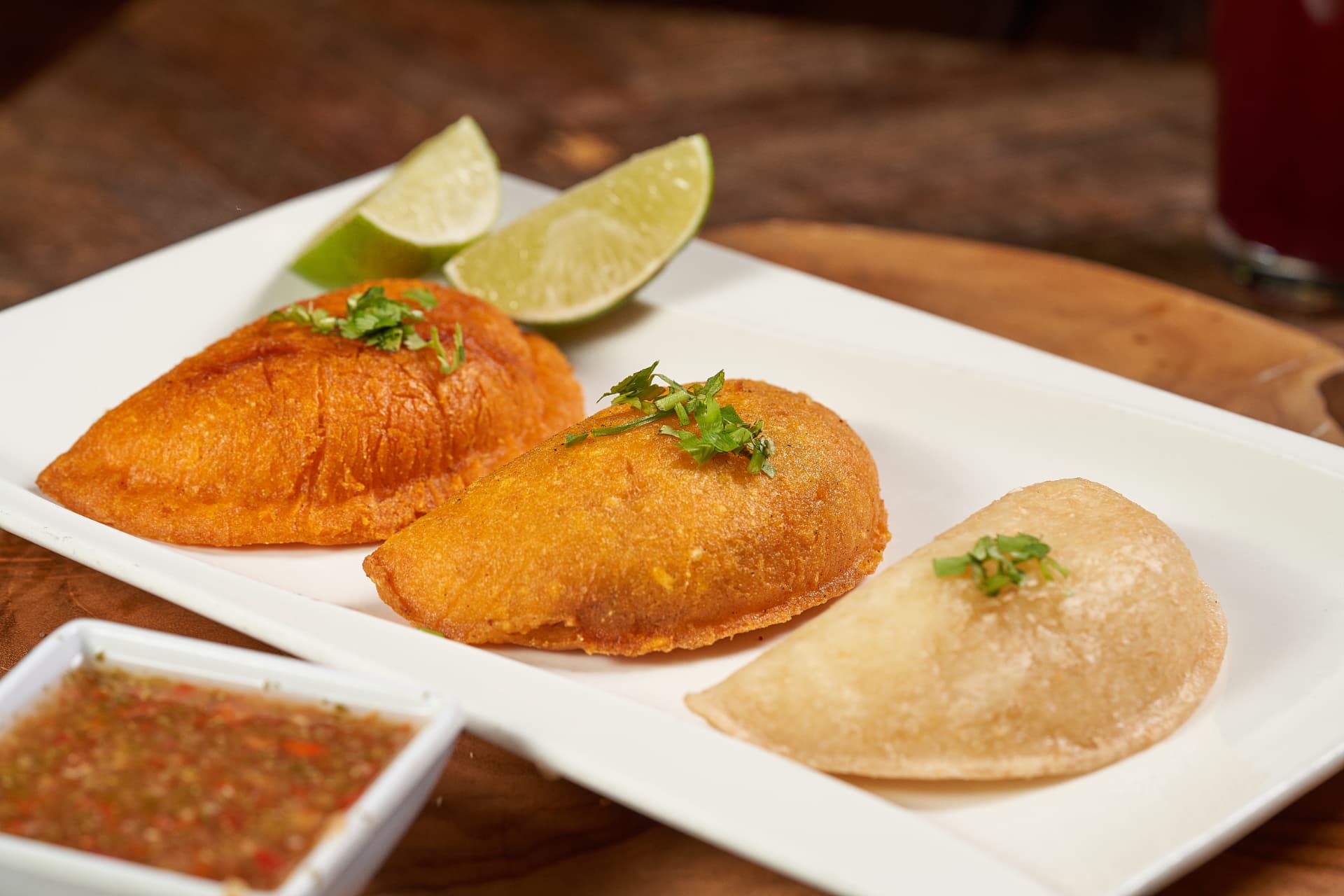 Golden Colombian empanadas with lime and aji
