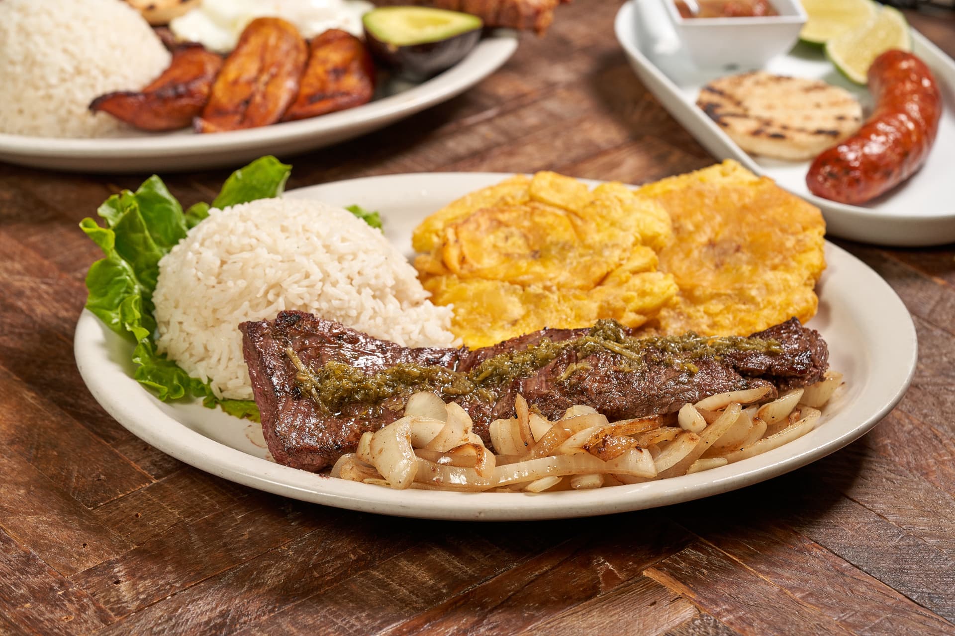 Grilled steak with chimichurri, rice and patacones